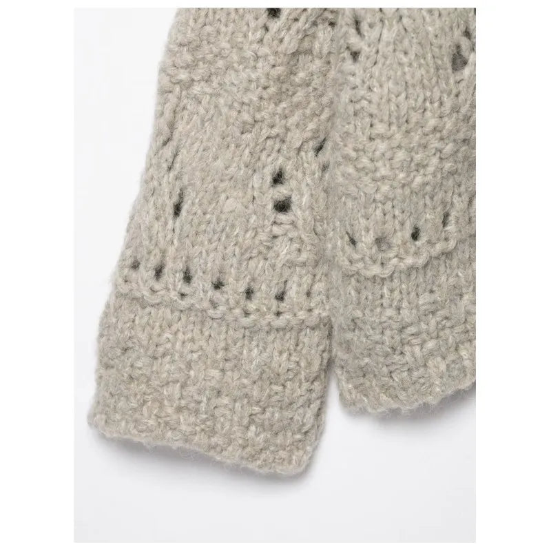 Sleeve and cuff detail of an oatmeal open knit cardigan