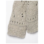 Sleeve and cuff detail of an oatmeal open knit cardigan