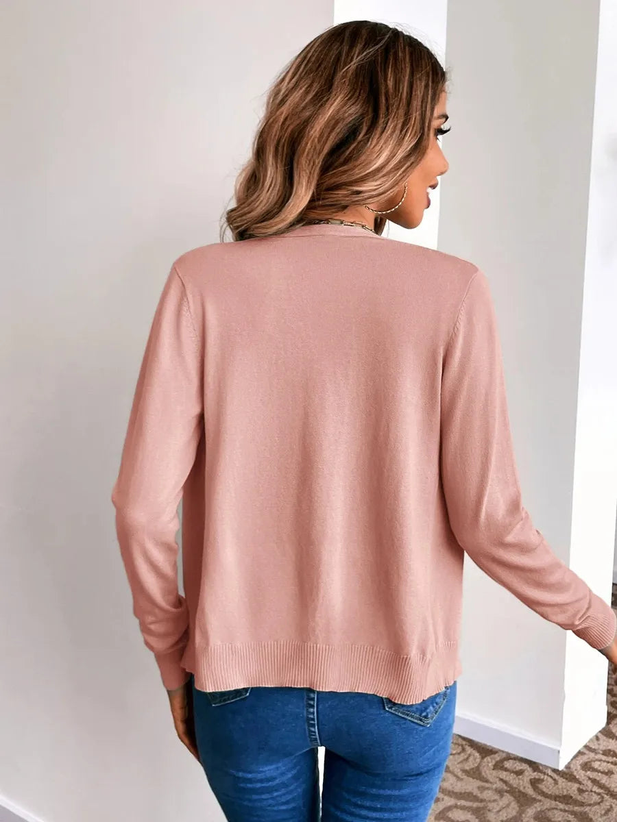Back view of a blush pink fine knit cardigan