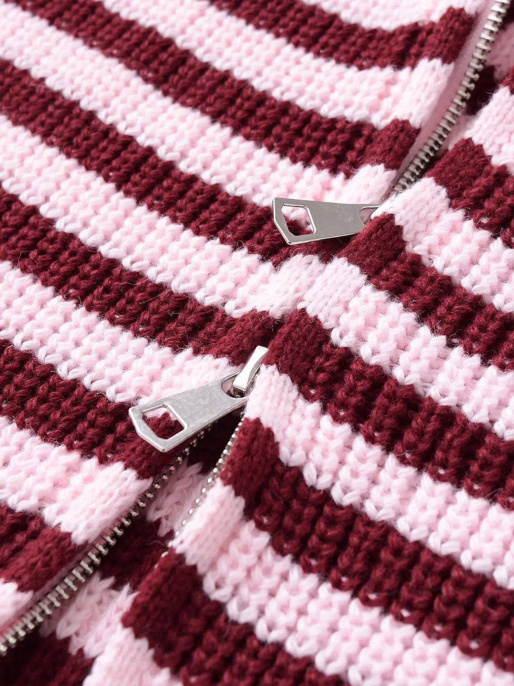 Close-up of the zip pulls on a burgundy striped cardigan
