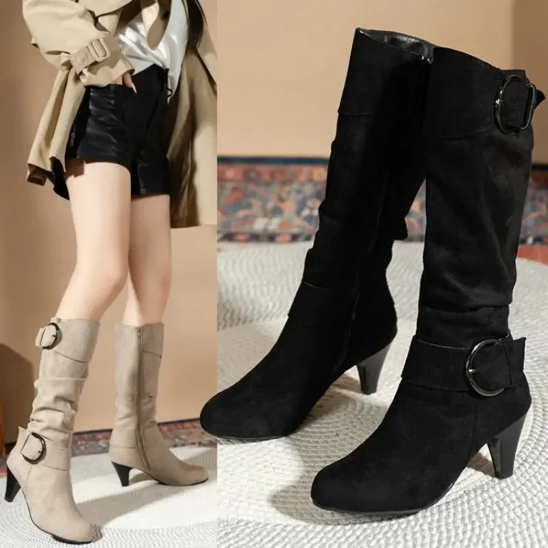 Black and beige slouchy heeled boots with ring buckle straps, styled with shorts