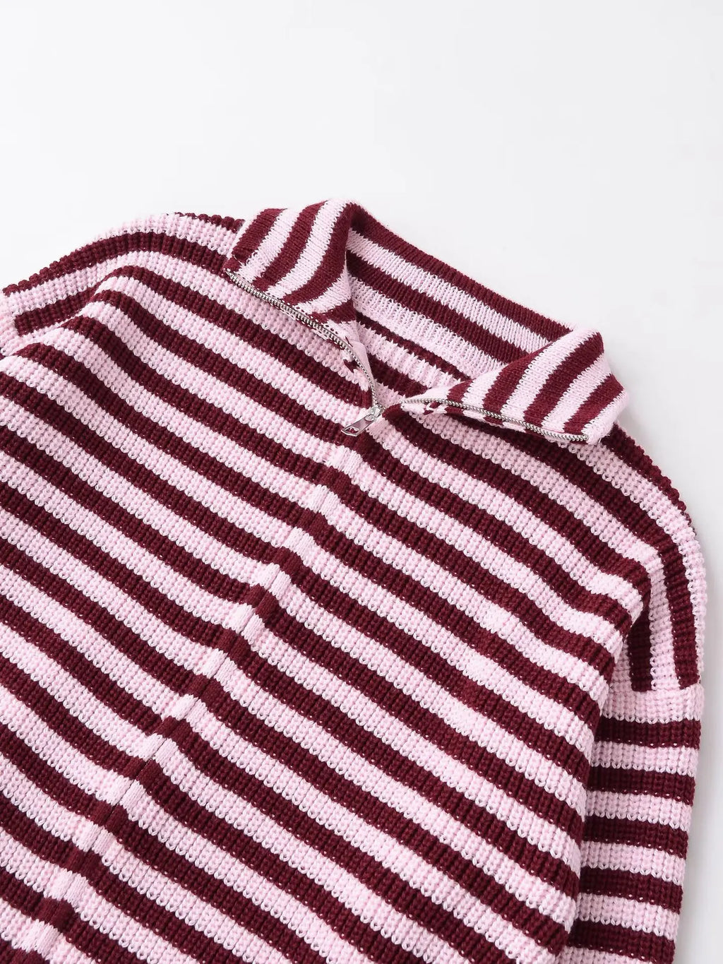 Close-up of the funnel neck and zip on a burgundy striped cardigan