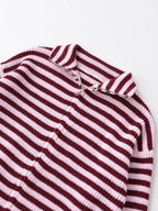 Close-up of the funnel neck and zip on a burgundy striped cardigan