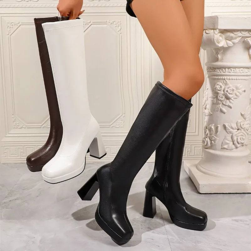 Black, white and brown platform knee high boots shown together