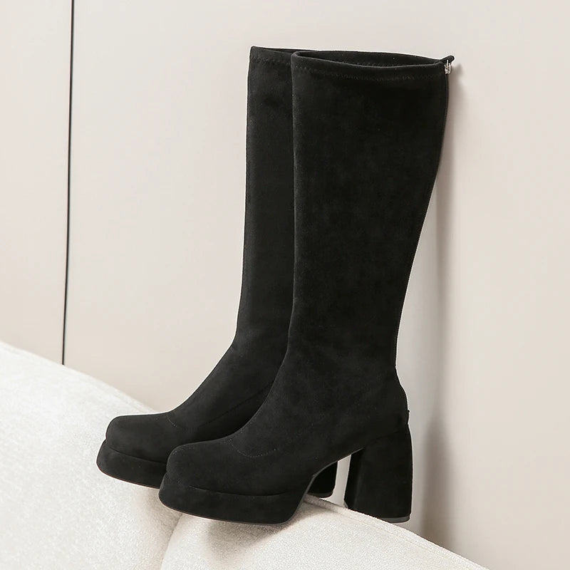 Black platform knee high boots with chunky block heel, side view