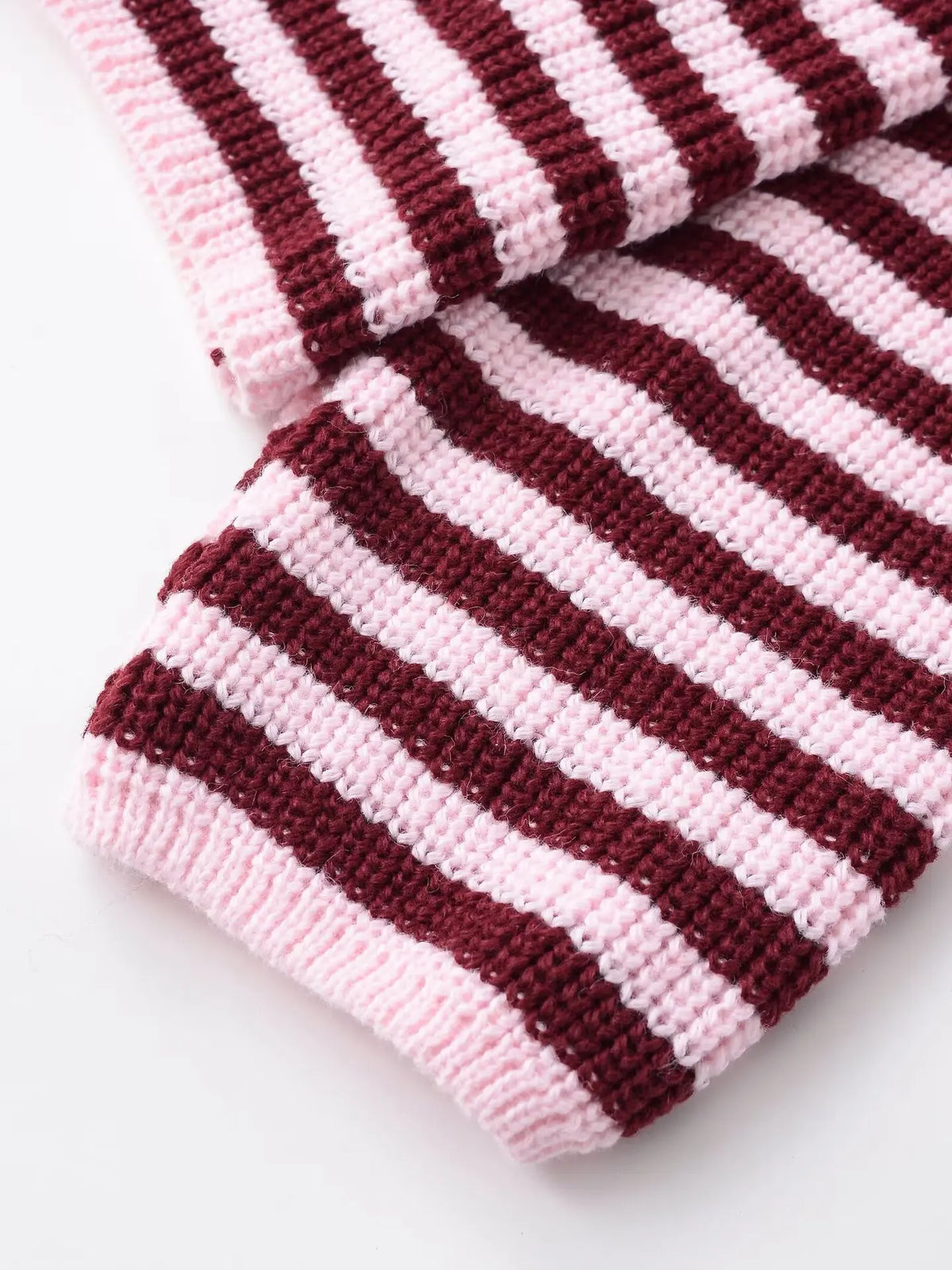 Close-up of the ribbed cuff on a burgundy striped cardigan